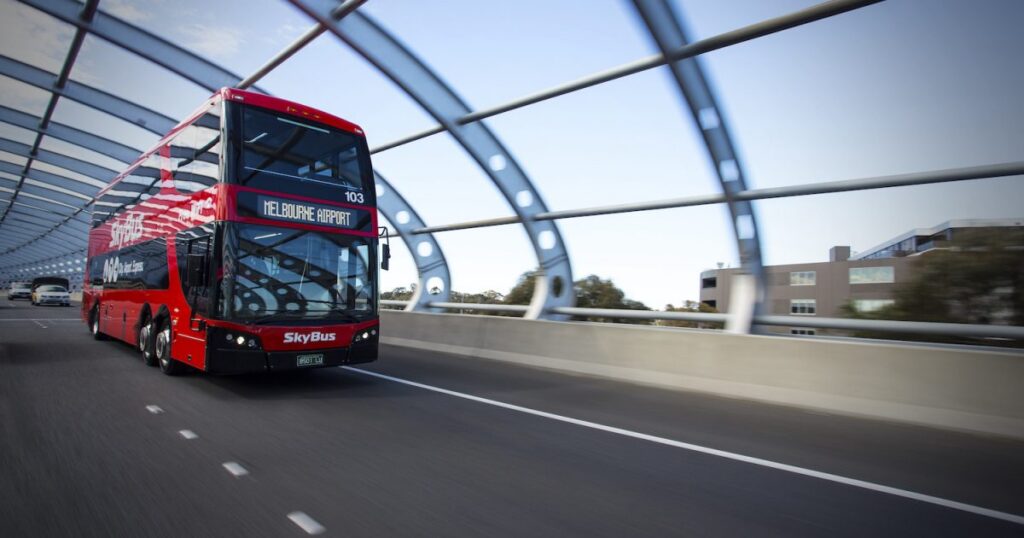 kinetic bus travelling through bridge road