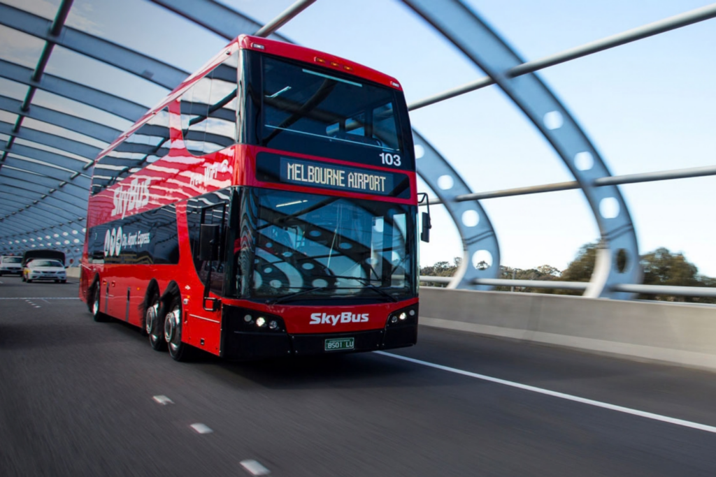 kinetic bus travelling through bridge road